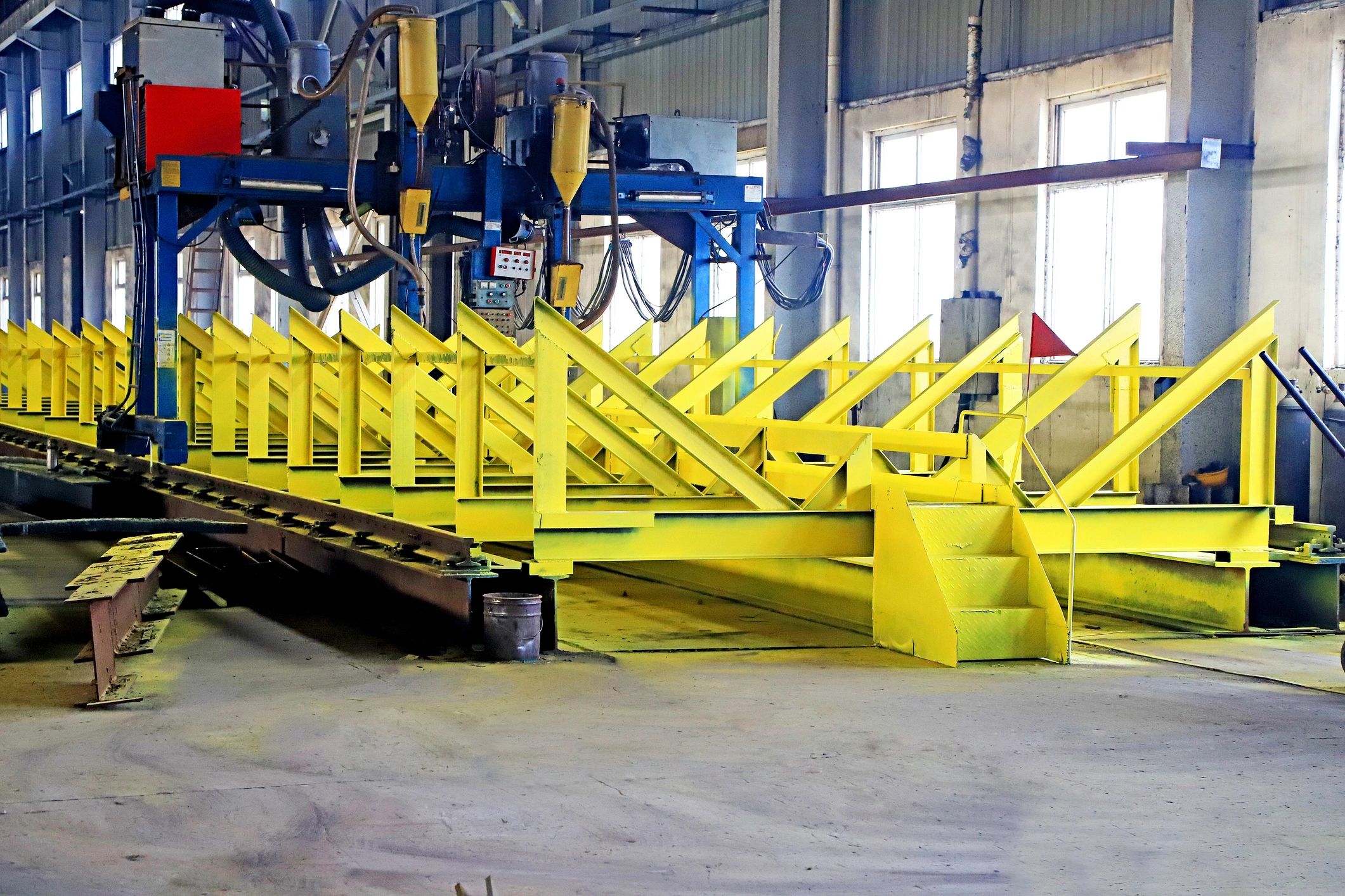 Industrial automated welding machine on a steel frame assembly line